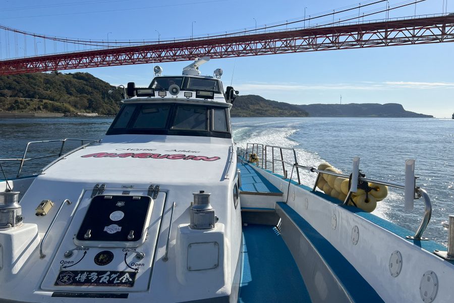 Fishing boat and red bridge